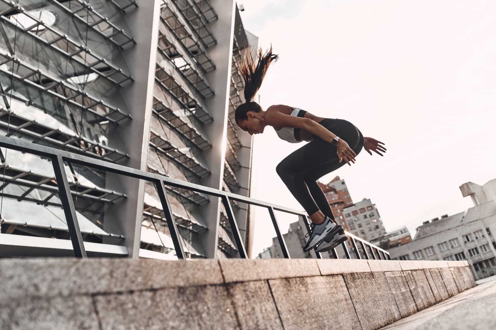 Woman jumping in an urban setting